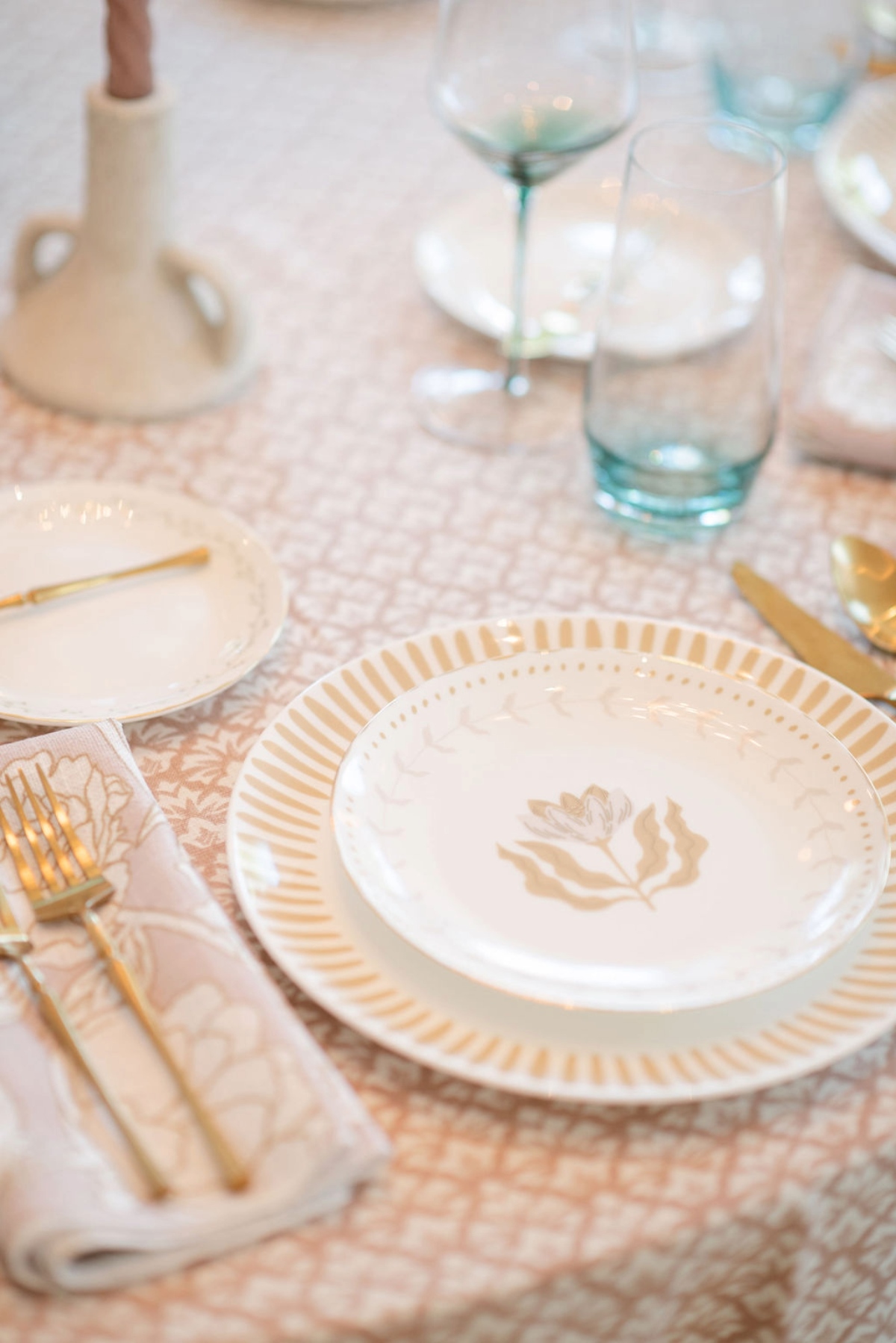 - Curated Linen Collection Romantic wedding tablescape with layered linens and folded napkins