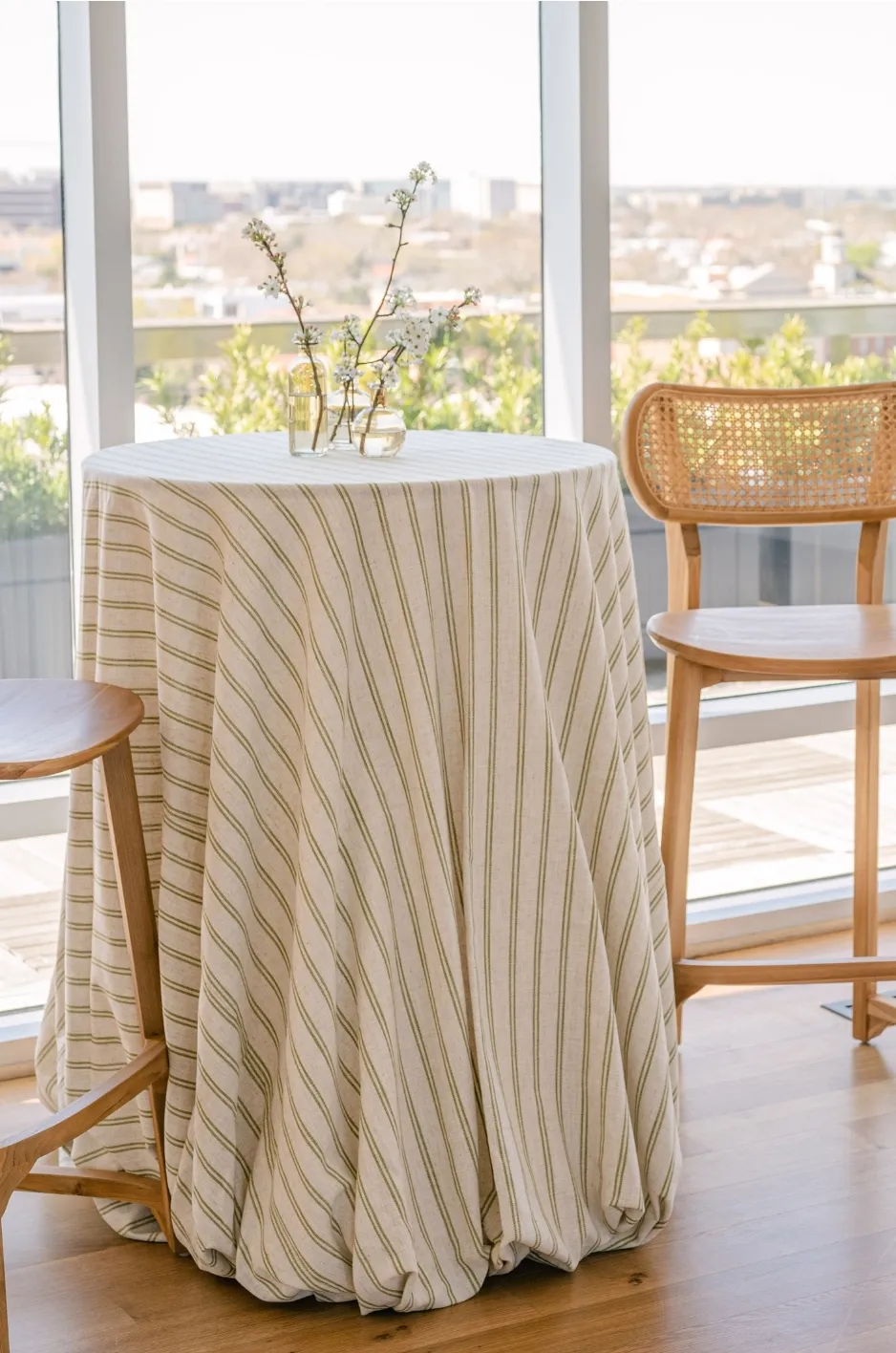 Striped floor-length linen on a round cocktail table