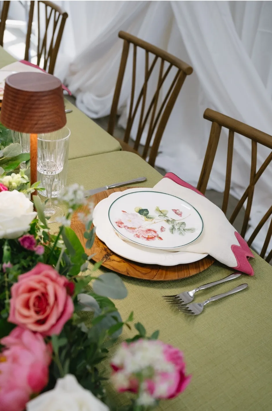 Refined place setting with a green table runner, floral china, wood charger, and fresh pink floral accents - Curated Linen Collection Luxury table runner and place setting detail, textured linen and floral centerpiece for upscale event