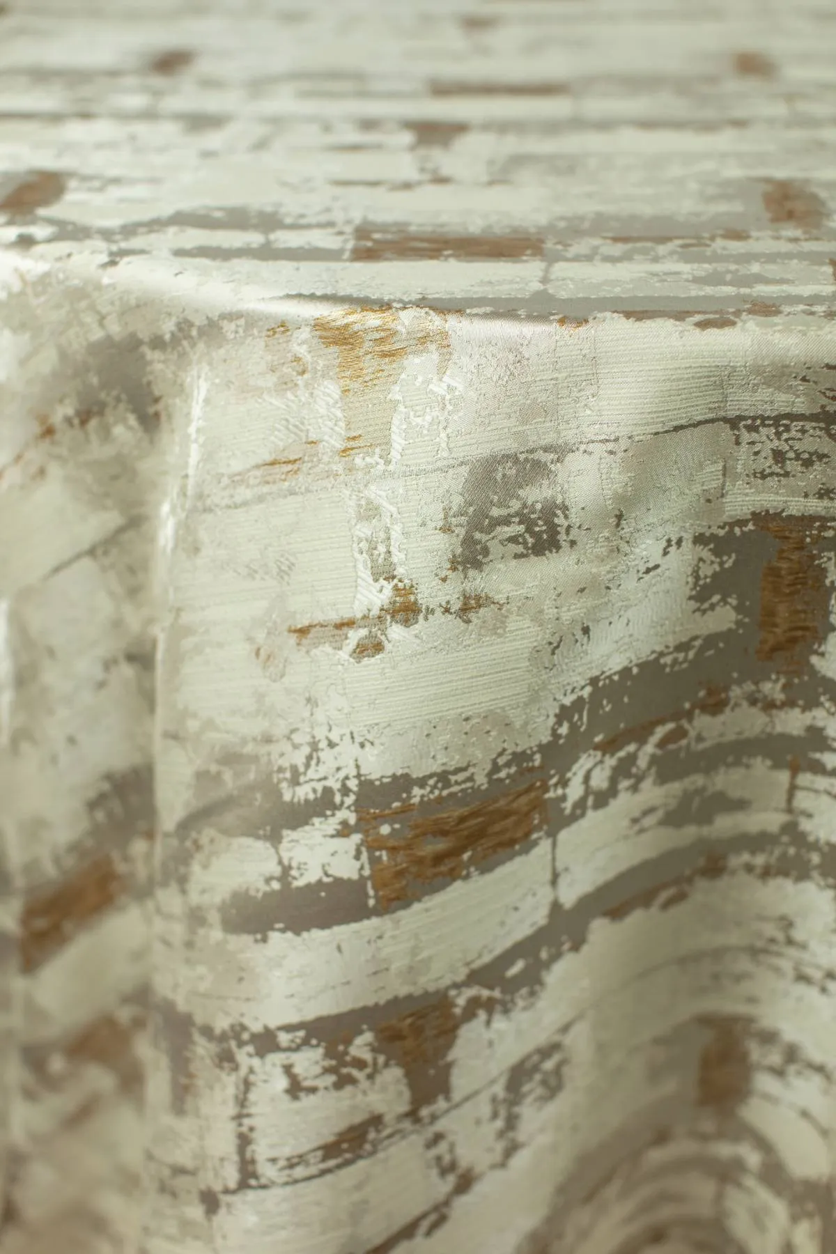 Close-up of cream, taupe, and bronze abstract textured event linen - Curated Linen Collection Close-up of cream, taupe, and bronze abstract textured event linen