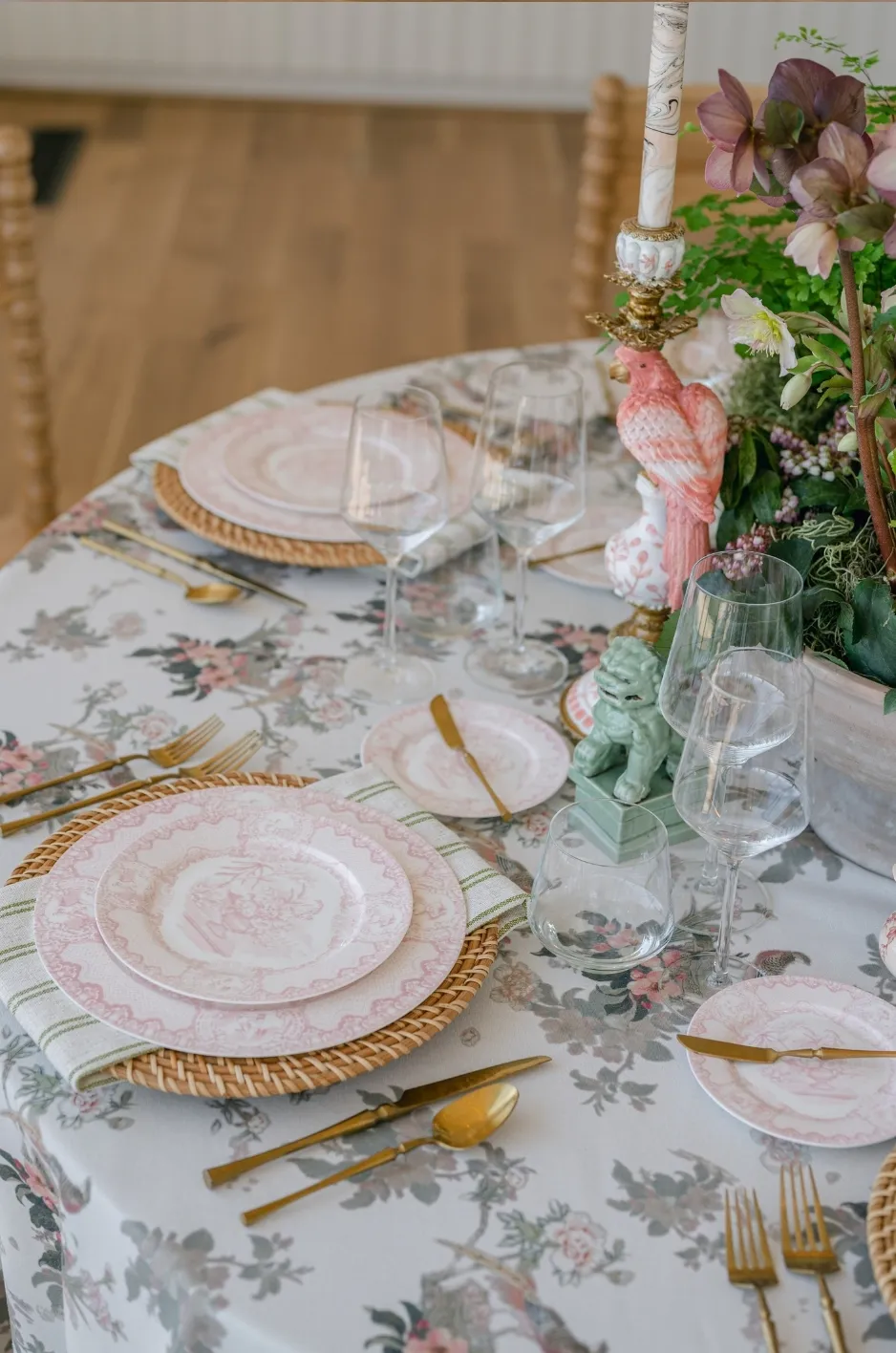 Sweetheart table with ivory textured linen, clear beaded chargers, grey napkins, and a low blue-and-white floral arrangement. - Curated Linen Collection Sweetheart table with ivory textured linen, clear beaded chargers, grey napkins, and a low blue-and-white floral arrangement.